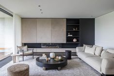 a living room filled with furniture and a fire place next to a sliding glass door