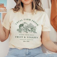 Whether you're a farmer, foodie, or just someone who appreciates the beauty of nature's bounty, this vintage-style fruits and veggies t-shirt is the perfect way to express your passion in style.  This is a unisex size T Shirt, please refer to the size chart pictured in the listing for choosing your perfect size. You will fall in love with this super soft tee with just the right amount of stretch! Its wildly comfortable and the unisex cut is flattering. It is one of our crowd favorites! It would make the perfect gift or grab it for yourself! It is sure you be your new favorite t shirt~ Our shirts are made with Direct to garment printing, not vinyl!  Which means your print will last longer and no peeling or cracking or fading! Yay!!  * Please read all details below. We want you to be complet Farmers Market Shirt, Quilt Size Chart, Flower Cottage, Nature's Bounty, Vegan Shirt, Gardening Shirts, Quilt Sizes, Farm Fresh, Floral Shirt