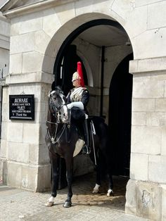 a man riding on the back of a black horse