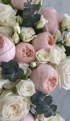 a bouquet of pink and white flowers on a table