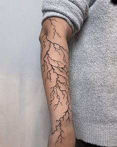 a man with a lightning tattoo on his arm