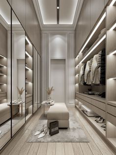 a large walk in closet with lots of clothes on the shelves and lights hanging from the ceiling