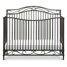 a black crib with white sheets on the bottom and side rails, against a white background