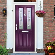 a black front door with potted flowers on the side