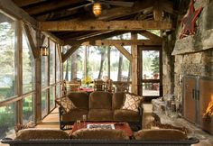 a living room filled with furniture and a fire place in the middle of an open floor plan