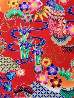 a red background with colorful flowers and plants