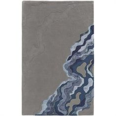 a gray rug with blue and grey waves on the bottom, in front of a white background