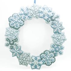 an ornament with snowflakes hanging from it