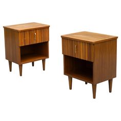 two wooden nightstands side by side with one open drawer and the other closed door