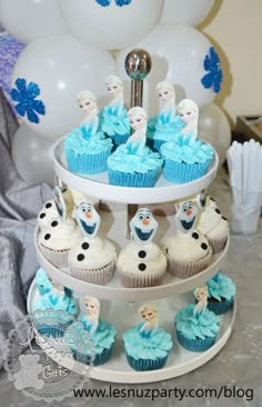 a three tiered cake stand with cupcakes on it