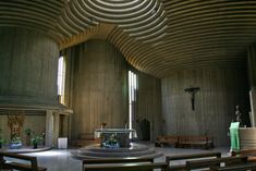 the inside of a church with pews and stained glass windows on both sides of the room