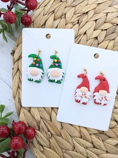 two christmas themed earrings sitting on top of a basket