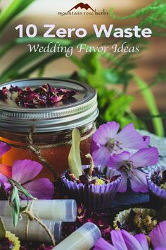 a jar filled with purple flowers next to lavenders and other items on top of a table