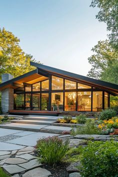 a modern house surrounded by trees and flowers