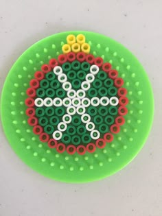 a green object with white and yellow circles on it