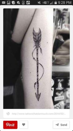 an arrow tattoo on the arm