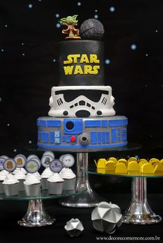 a star wars themed birthday cake and cupcakes on a table with space in the background