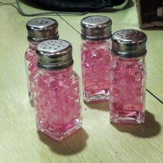 three salt and pepper shakers sitting on a table