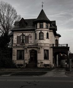 an old victorian style house with a steeple on the roof and two story windows