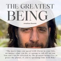 a man with long hair and beard in front of a white sign that says the greatest being