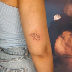 a woman's arm with a small tattoo on the left side of her arm