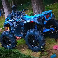 a blue four wheeler parked in the grass