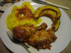 a white plate topped with chicken, rice and squash