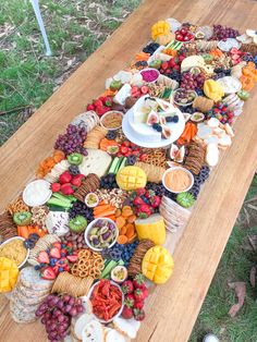 a wooden table topped with lots of different types of food and snacks on it's side