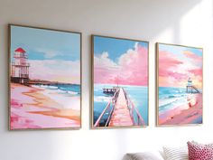 three paintings hang on the wall above a couch