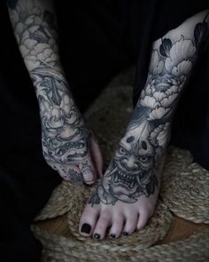 a person with black and white tattoos on their feet