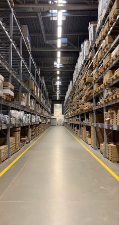 a large warehouse filled with lots of shelves and boxes on top of each shelf in front of the camera