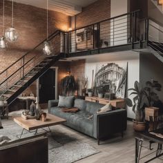 a living room filled with furniture next to a stair case in front of a brick wall