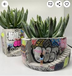 there is a potted plant with graffiti on it and a woman standing in front of it