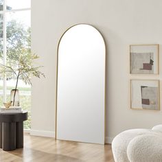 an arched mirror in the corner of a room