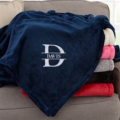 towels and blankets are stacked on top of a couch with the word davis printed on them