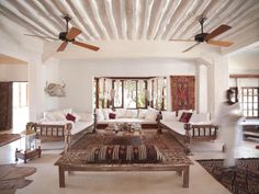 a living room filled with lots of white furniture