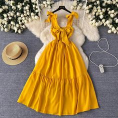 Summer Yellow Womens Dress with Bow Tie Straps Yellow Tie-back Dress For Vacation, Casual Beach Dresses With Bow Detail, Casual Beach Dress With Bow, Casual Summer Dress With Bow, Sleeveless Beach Dress With Bow, Beach Sleeveless Dress With Bow, Summer Picnic Dress With Bow Detail, Chic Dresses With Bow Straps For Vacation, Spring Beach Dress With Bow Detail