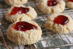 small cookies with jam on them cooling on a rack