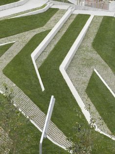 an aerial view of a grassy area with white steps and railings in the grass