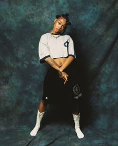 a woman in white shirt and black skirt posing