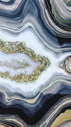 an aerial view of the surface of a marbled table with gold and black accents