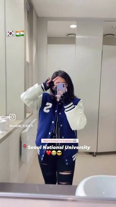 a woman taking a selfie in a bathroom mirror with her cell phone up to her face