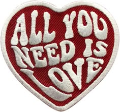 a red and white patch with the words all you need is love in it's center