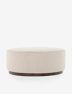 a round ottoman that is white and brown