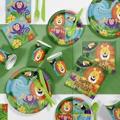 an animal themed birthday party set with plates and napkins