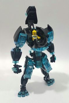 an action figure made out of legos on a white surface with blue and black colors