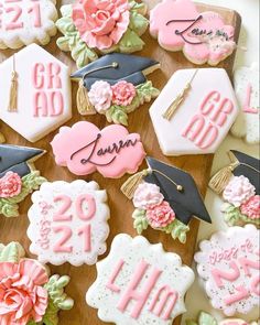 decorated cookies with graduation caps and flowers are on a wooden board that says class of 2013