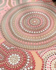 a pink and brown table cloth with circles in the center on top of each other