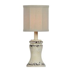 a white table lamp with a beige shade