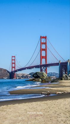 the golden gate bridge in san francisco, california is seen from the beach below it